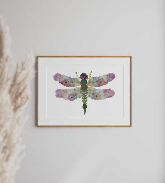 pressed flower botanical dragonfly artwork with pink, white and blue flowers and greenery.
