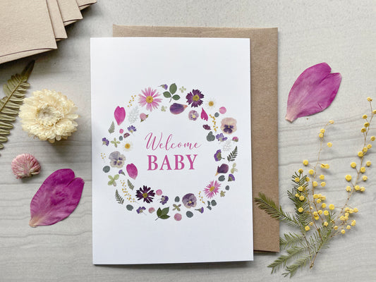 welcome baby card with pink and purple pressed flowers