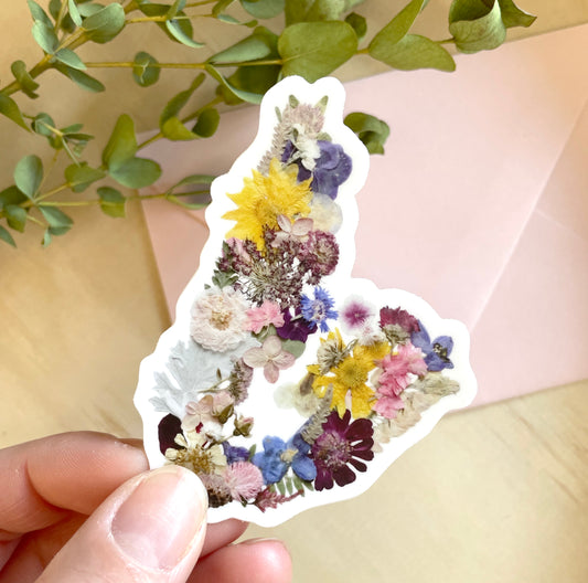 sticker of cape breton map made with dried pressed flowers grown in nova scotia and creatively arranged to look like cape breton island.