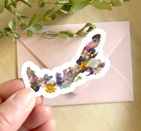 sticker of prince edward island map made with colourful dried pressed flowers.