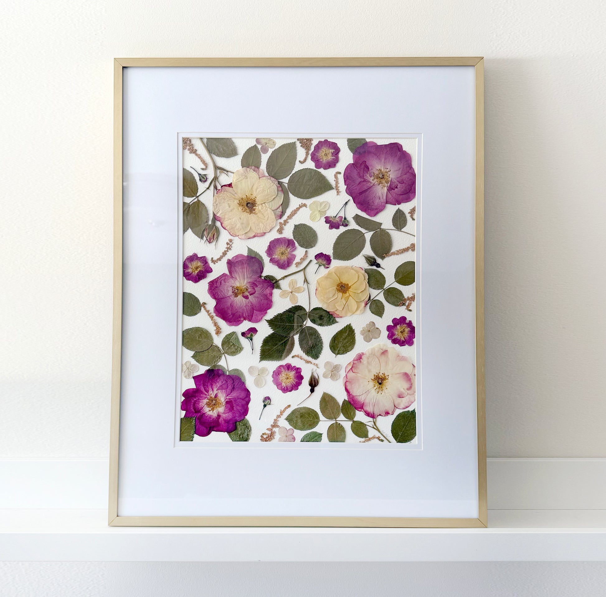 Framed botanical print with preserved roses, pressed flowers on a white background