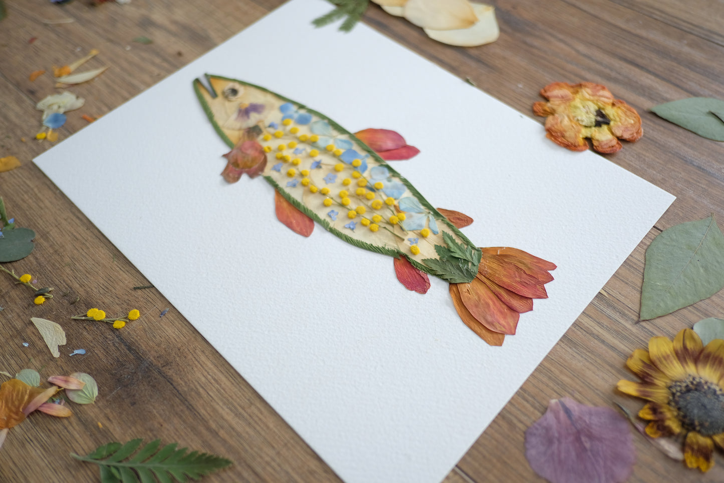 Pretty Trout Fish Artwork made with orange, blue, yellow flowers and greenery.