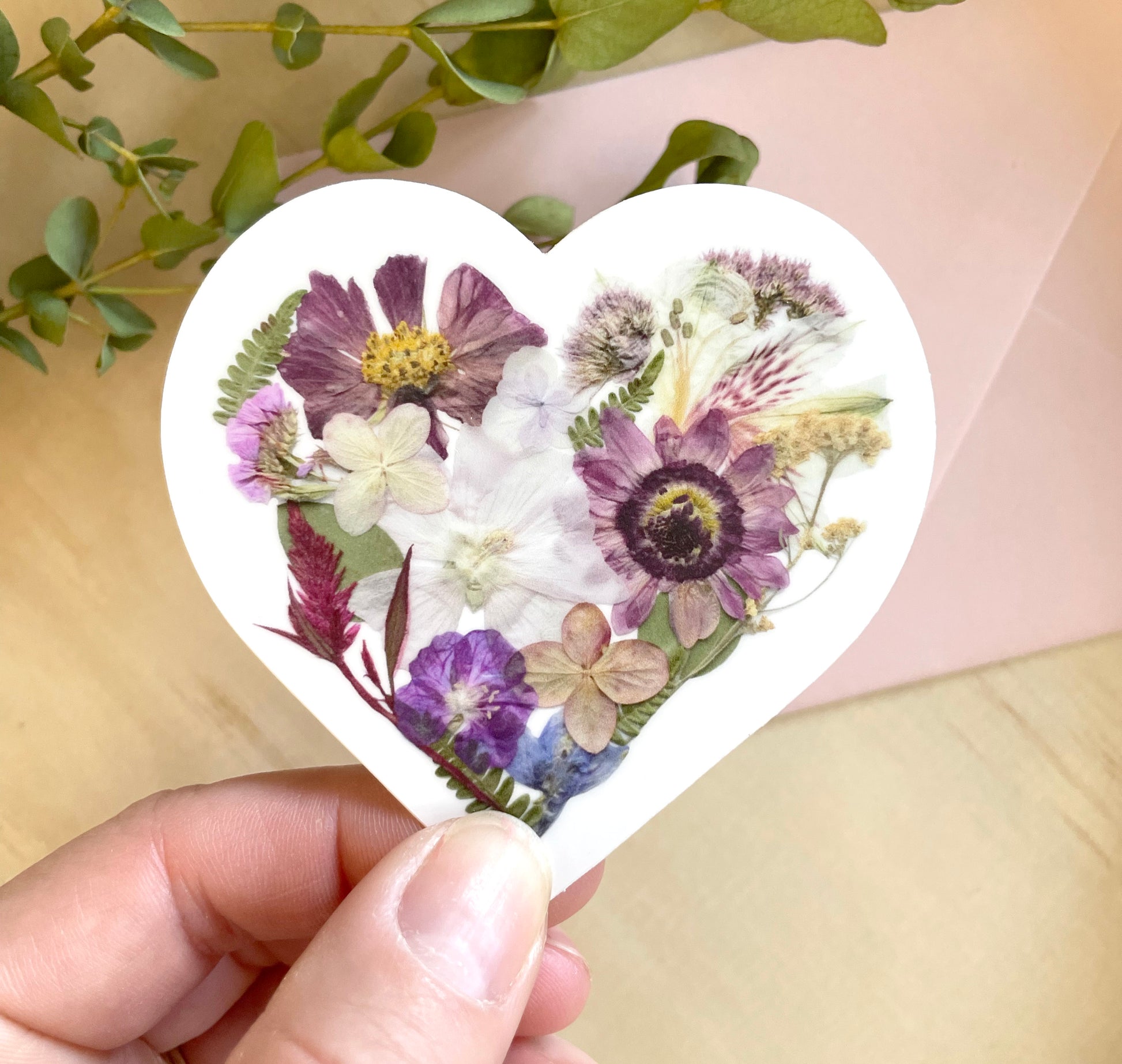 sticker of floral heart made with dried pressed flowers. 
